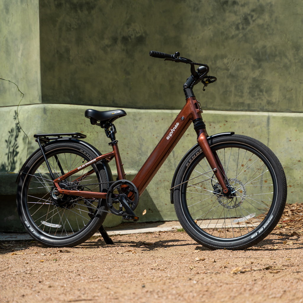 Solar Sparrow electric bike in Americano parked at the park, showcasing step-through frame and commuter-ready design