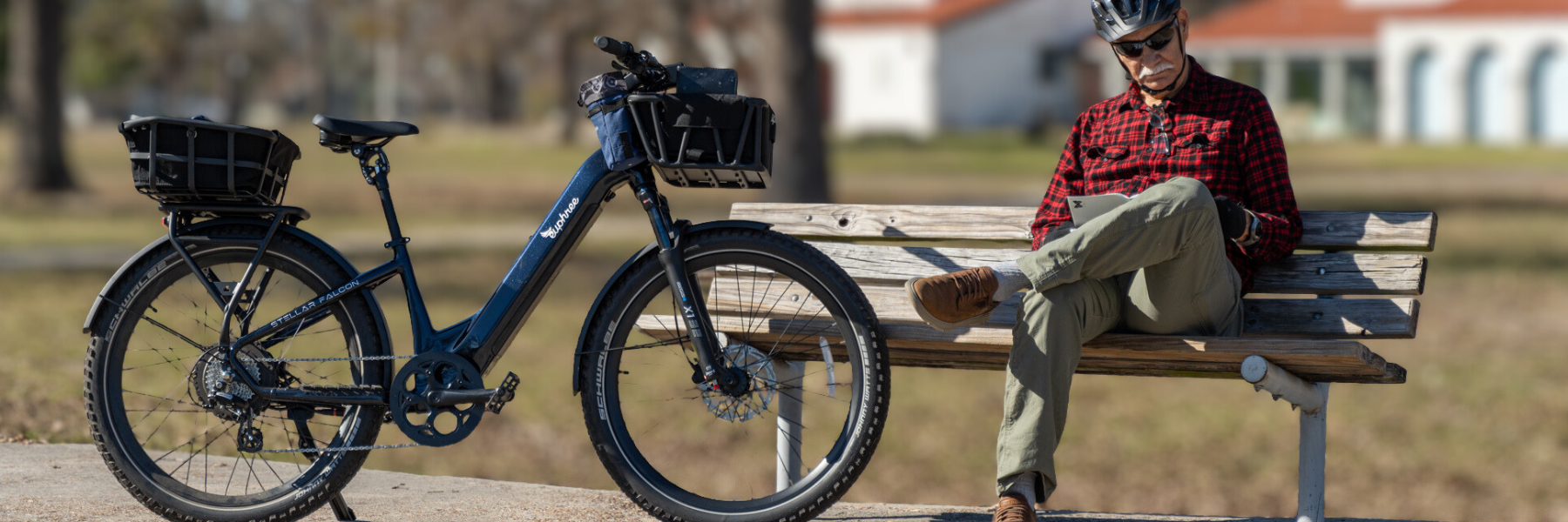 Man riding Euphree Stellar Falcon ebike at the park equipped with trunk bag, gloves, and bike mirror accessories for comfort and safety