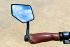 Left bike mirror mounted on a City Robin X+ ebike outside, showcasing the adjustable mirror for improved rear visibility during rides.