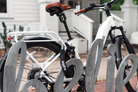 Euphree Café Lock Chain in use on a white City Robin X+ at a coffee shop, securely wrapped around a pole, showcasing its compatibility with Café Lock-equipped models for enhanced bike protection.