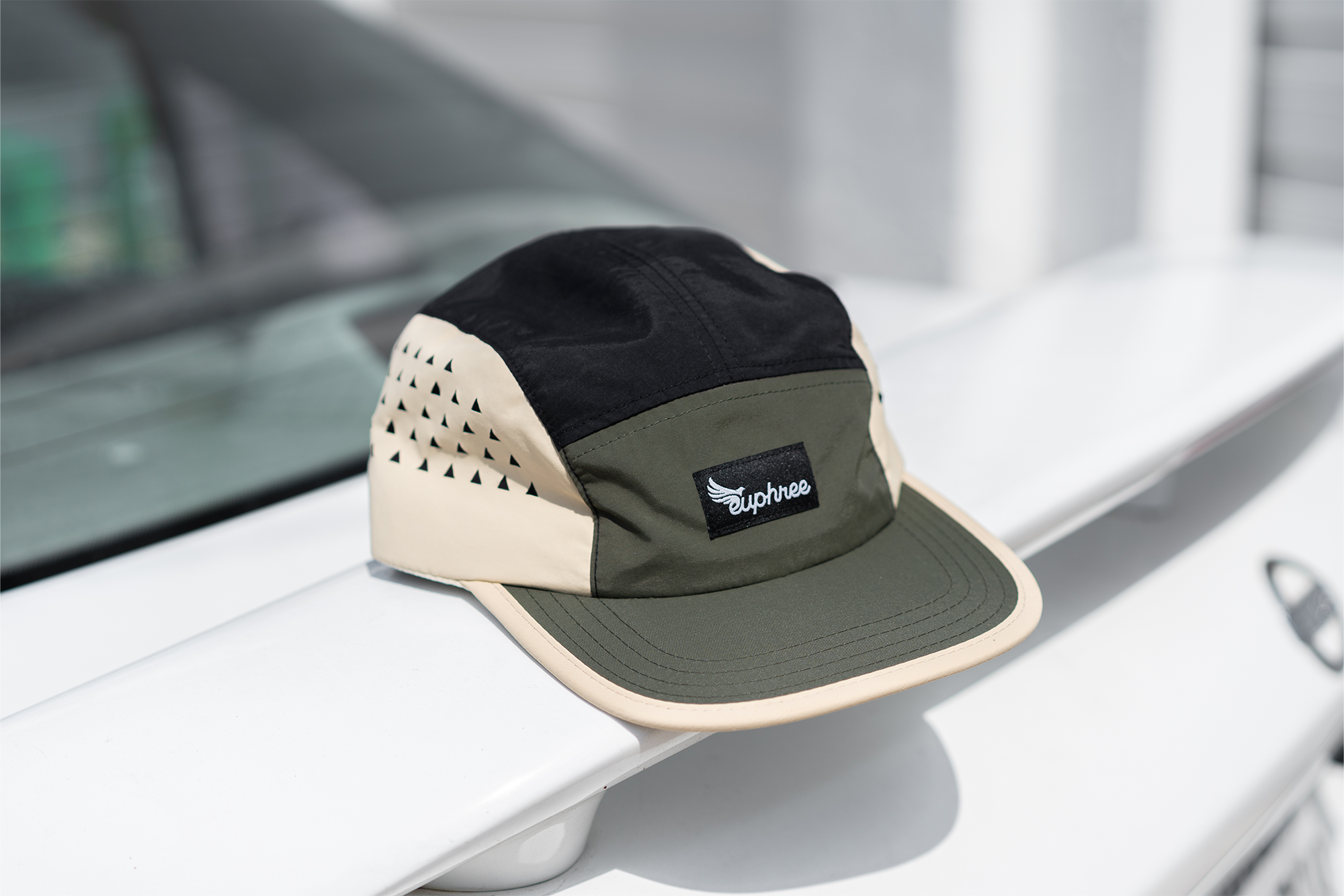 Euphree Velocity 5-Panel Nylon Cap in green, placed on a truck, showcasing its stylish design and practical use for cycling and everyday wear.