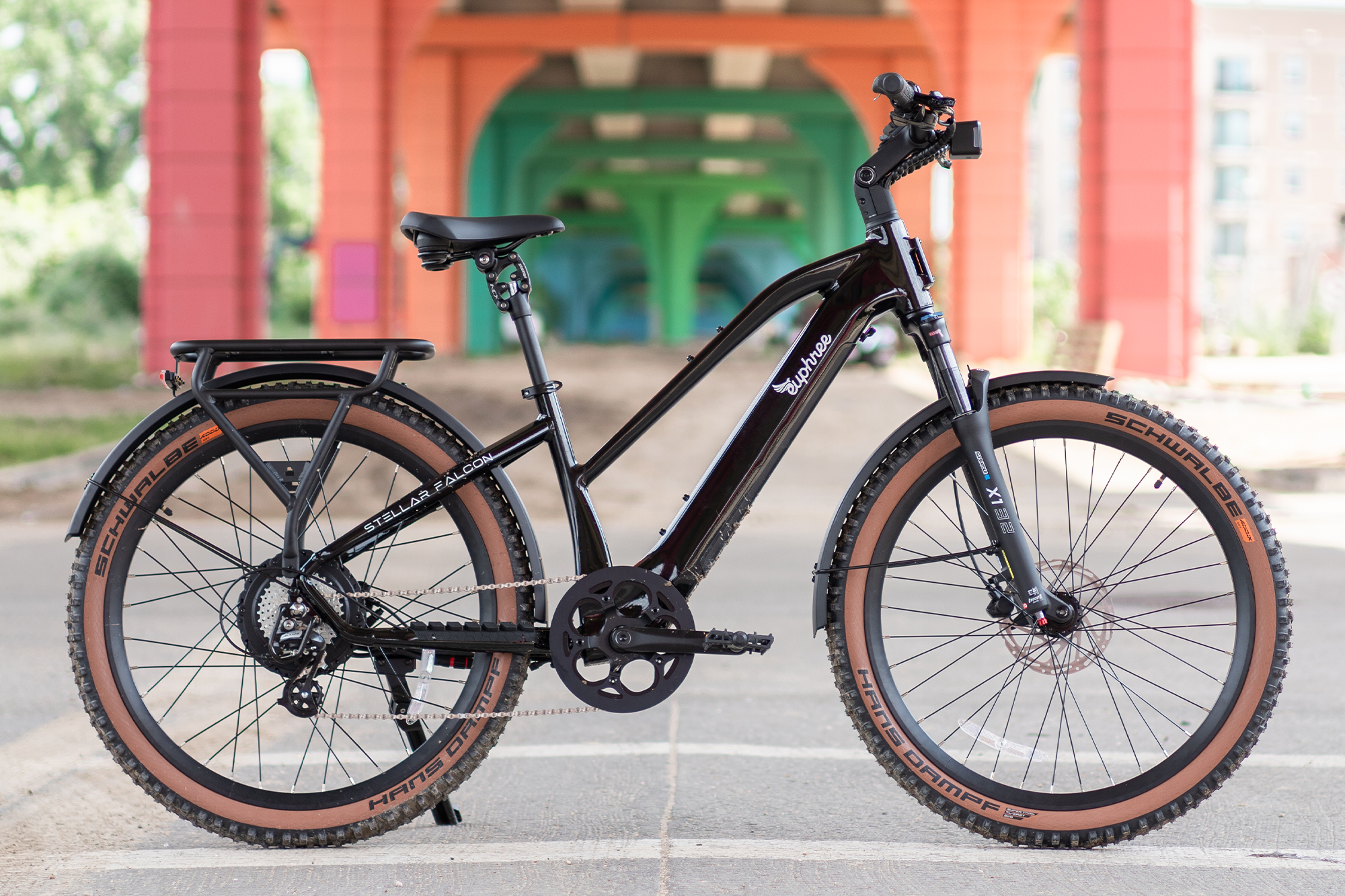 Stellar Falcon Mid-Step electric bike in black with Hans Dampf tires, photographed in the outdoors, featuring a 750W motor and air suspension for rugged terrain