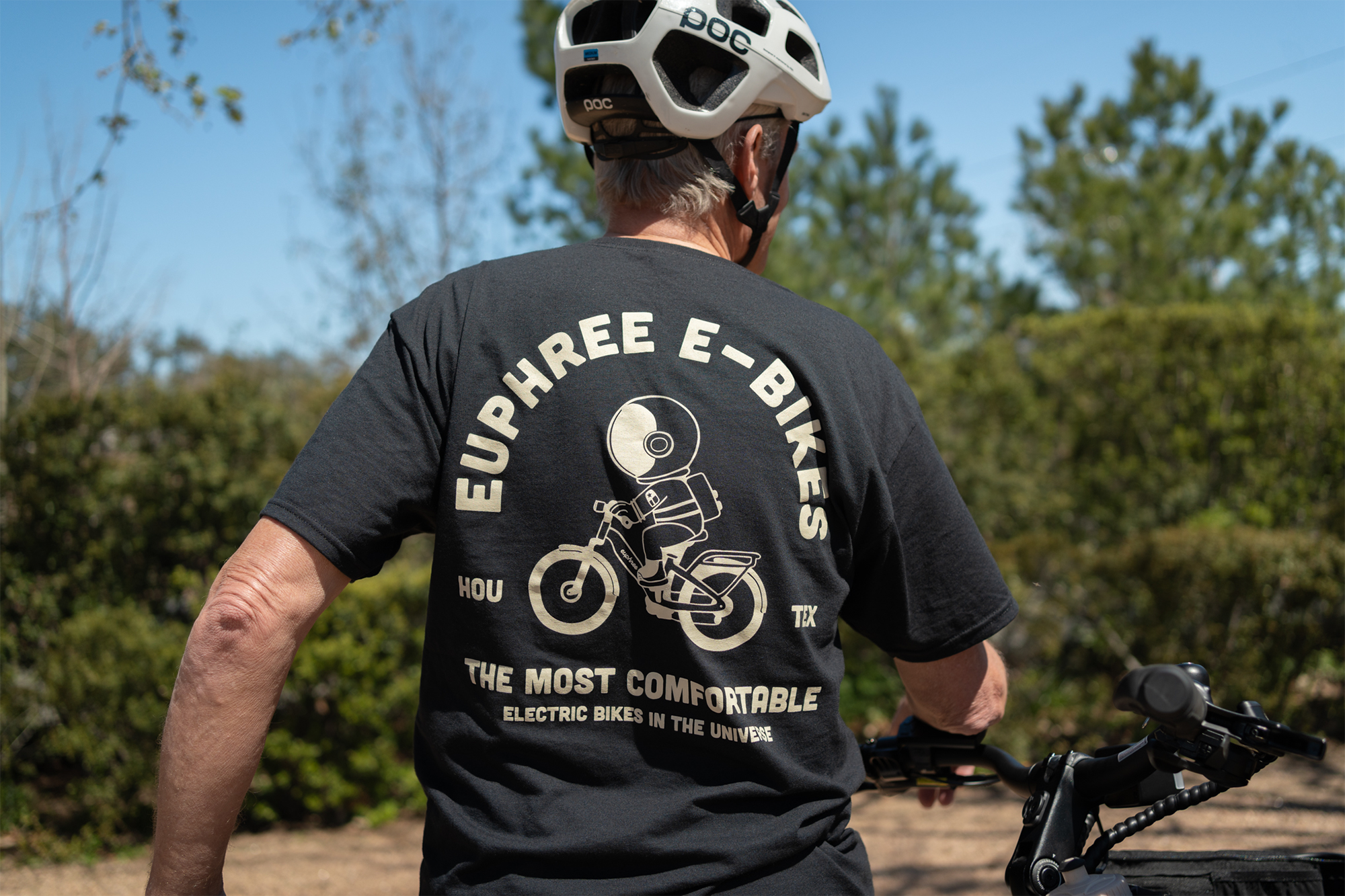 Man wearing Euphree electric bike T-shirt at the trails, showing the back of the shirt