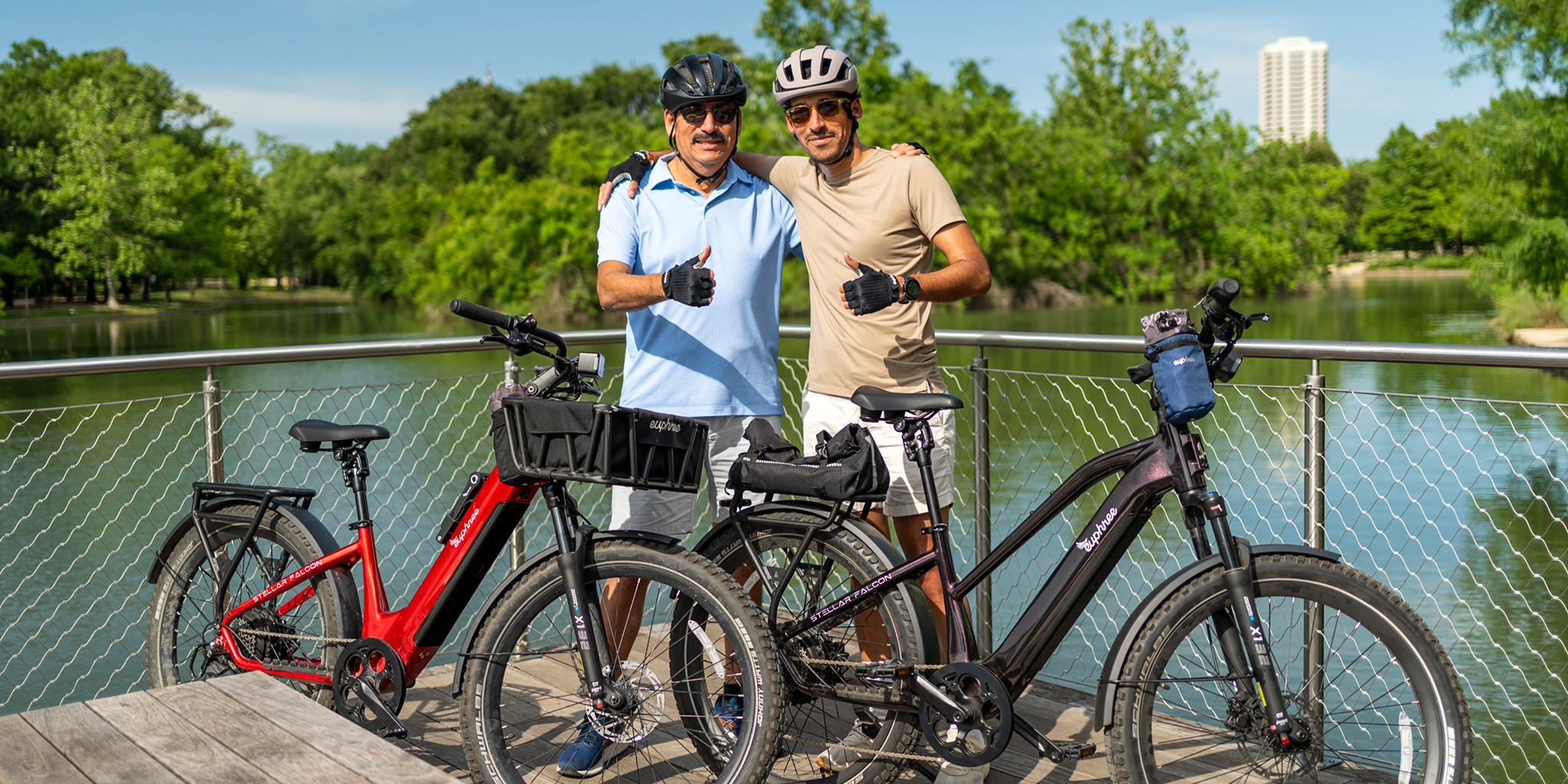 Father and son giving two thumbs up after trail ride on their Euphree Stellar Falcon ebikes—Step-Thru in Crimson Red and Mid-Step in Black Cherry